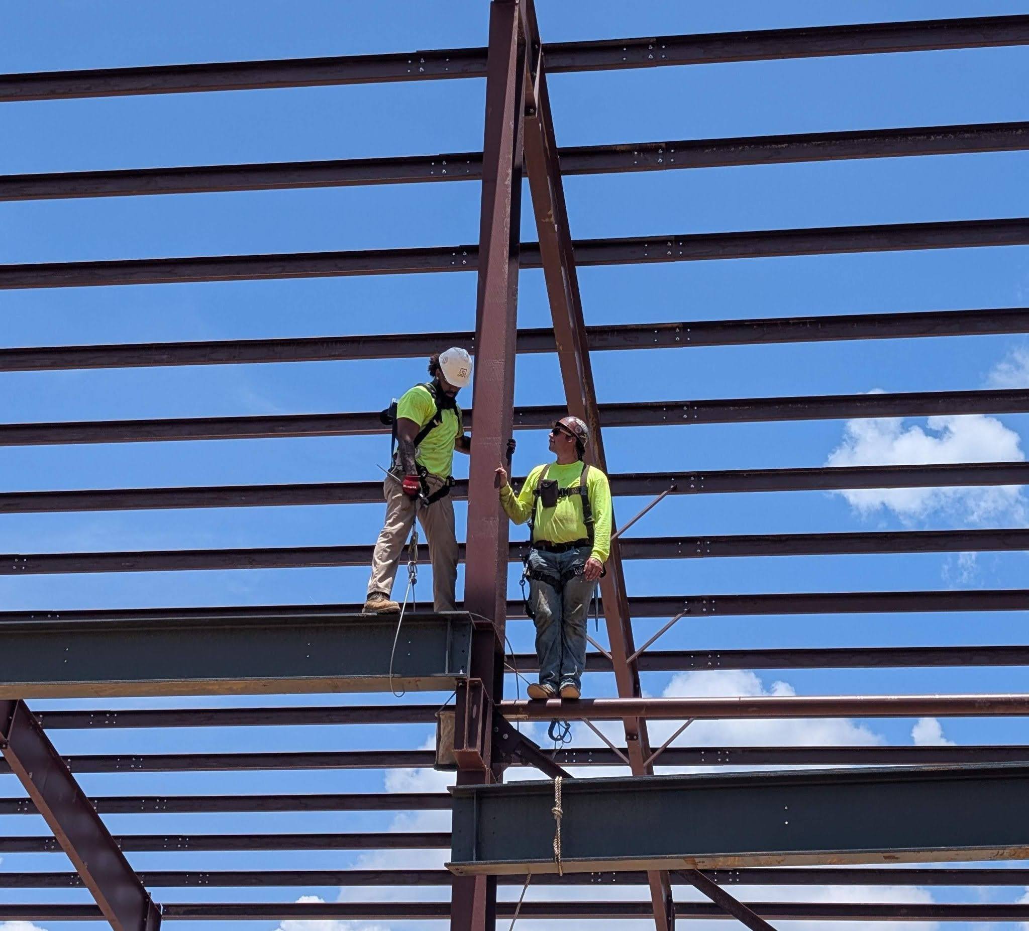 Crane 1 certified technician performing overhead crane repair and inspection inside an industrial facility.